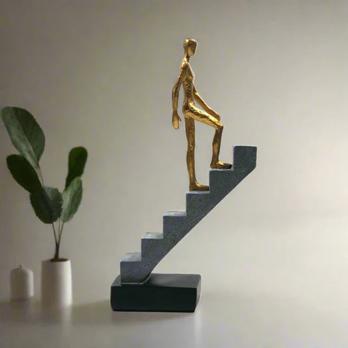 Resin Man Walking Up Stairs Statue