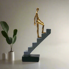 Resin Man Walking Up Stairs Statue