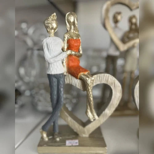 Couple Holding Hands With Heart Statue