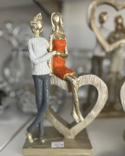 Couple Holding Hands With Heart Statue