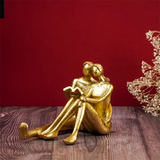 Golden Couple Reading Book Sculpture